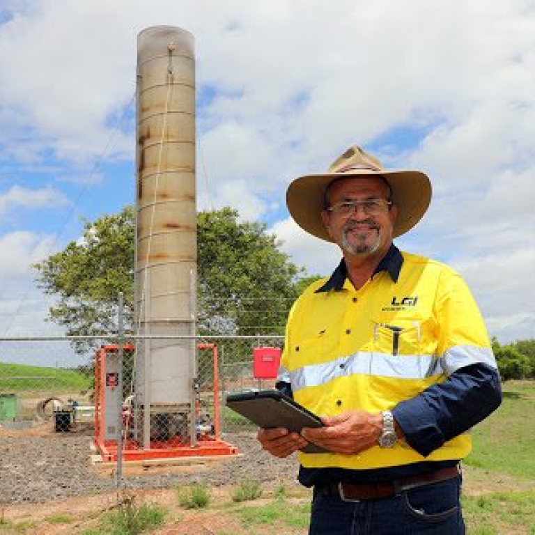 LGI smiling staff member onsite with tablet
