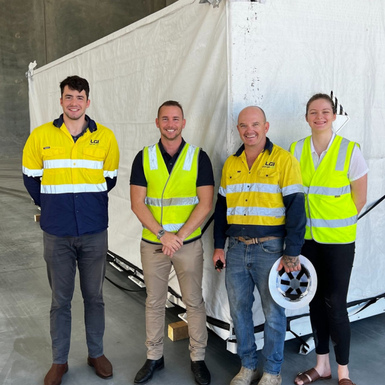 LGI team smiling in warehouse